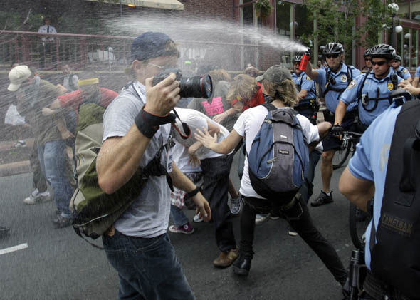Police use pepper spray to break up a group of protesters during a rally at the Republican National Convention in St. Paul, Minn., Monday, Sept. 1, 2008. (AP Photo/Matt Rourke)
