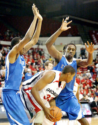 Junior Perry Stevenson, left, and sophomore Patrick Patterson guard a Georgia Bulldog during UKs game against Georgia on Sunday, Jan. 18, 2009. UK defeated Georgia 65-48 behind 11 blocks on Sunday. Photo by Zack Brake