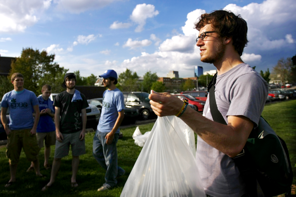 Secondary english education junior, Matt Kramer holds a bag to collect the trash found around campus for the Campus Clean-up event on Wednesday afternoon. Photo by Adam Wolffbrandt