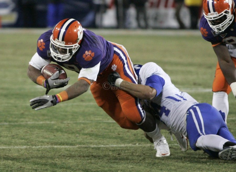 Clemson's running back Jamie Harper gets tackled by UK cornerback Paul Warford in the second half of the UK football game against Clemson at L. P. Field for the Gaylord Hotels Music City Bowl on Sunday, Dec. 27, 2009. The Cats lost to the Tigers 21-13. Photo by Adam Wolffbrandt