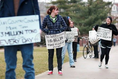 Members of UK Beyond Coal hold signs in a silent demonstration on Tuesday morning to encourage UK Presidnet Lee Todd to move away from coal and find an alternative energy source for campus. Photo by Allie Garza