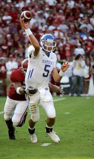 Allie Garza//Kentucky Kernel Sophomore quarterback Mike Hartline throws a pass while Alabama junior linebacker Eryk Anders goes in for the tackle during the beginning of the third quarter.