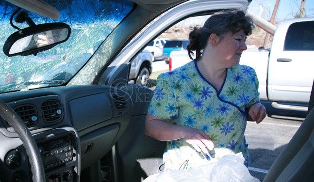 Marie Elam, an RN at Appalachian Regional Hospital clinic, salvages what she can out of her destroyed Chevrolet Trailblazer. in West Liberty, Ky. March 3, 2012. Elam said she lives in Breathitt Co., and had not been home to check on her house. She has worked at ARH clinic for 14 years. Photo by Brandon Goodwin