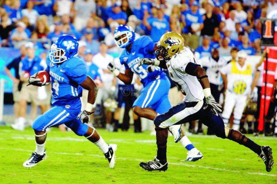 Despite only being a sophomore, UK running back Raymond Sanders, seen here carrying the ball against Akron last season, has taken on a leadership role at the position. Photo by Britney McIntosh