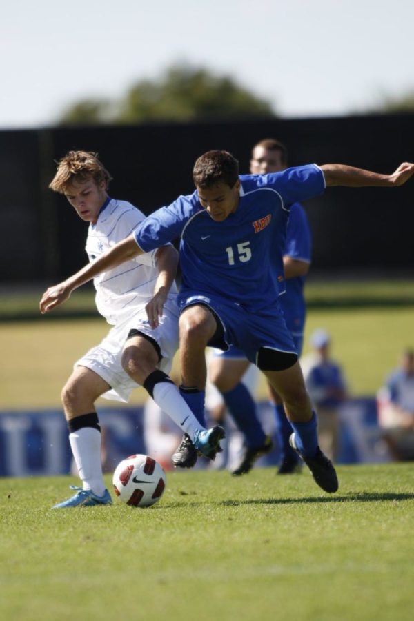The+UK+mens+soccer+team+played+to+a+tie+after+two+overtimes+against+Houston+Baptist+University+Sunday+afternoon.+UK+foreward+Tyler+Riggs+fends+off+HBU+defender+Walter+Kromholz.+John+Foster