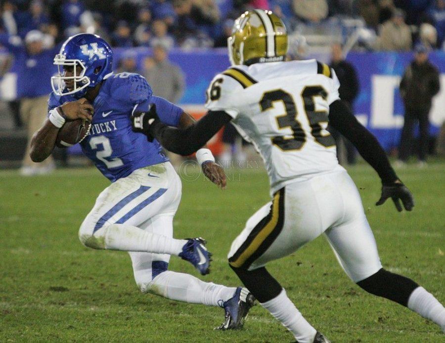 UK quarterback Jalen Whitlow (2) dashes past Alabama State cornerback Bradley Street (36) during UK's homecoming game vs. Alabama State at Commonwealth Stadium in Lexington, Ky., on Saturday, November 2, 2013. Photo by Adam Pennavaria