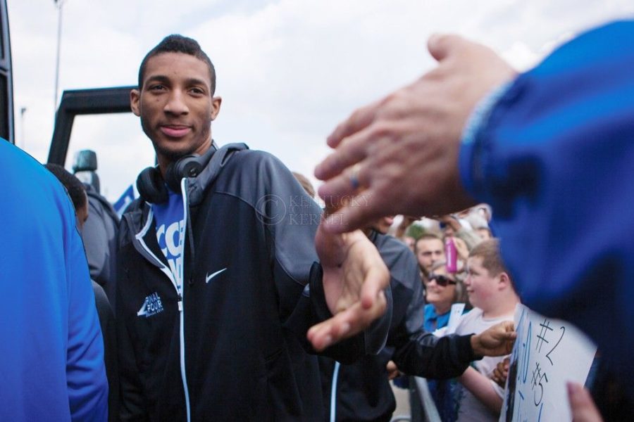 Kentucky forward Marcus Lee shakes hands with a fan at Blue Grass Airport as the Cats return to Kentucky in Lexington, Ky., on Tuesday, April 8, 2014. Photo by Adam Pennavaria