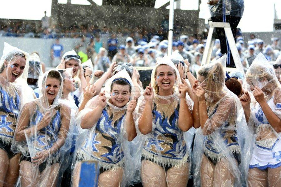 Kentucky+colorguard+cheers+on+the+Wildcats+through+the+rain+during+the+second+half+of+the+game+against+the+Ohio+Bobcats+at+Commonwealth+Stadium+in+Lexington%2C+Ky.%2C+on+Saturday%2C+September+6%2C+2014.+Kentucky+wins+20-3.+Photo+by+Caleb+Gregg