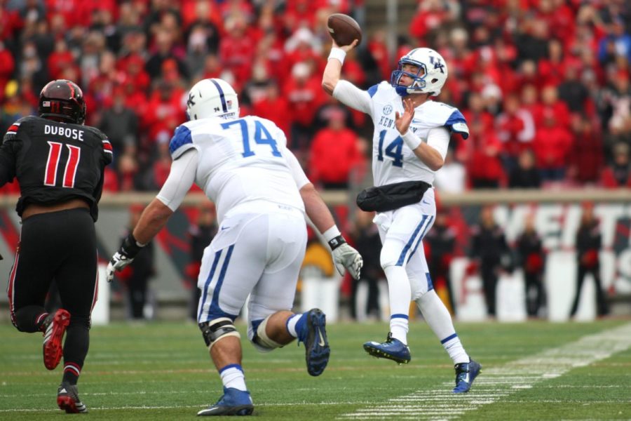 Quarterback Patrick Towles of the Kentucky Wildcats passes during the first half of the game against the Louisville Cardinals at Papa Johns Cardinals Stadium on Saturday, November 29, 2014 in Louisville, Ky. Louisville leads Kentucky 21-13. Photo by Michael Reaves