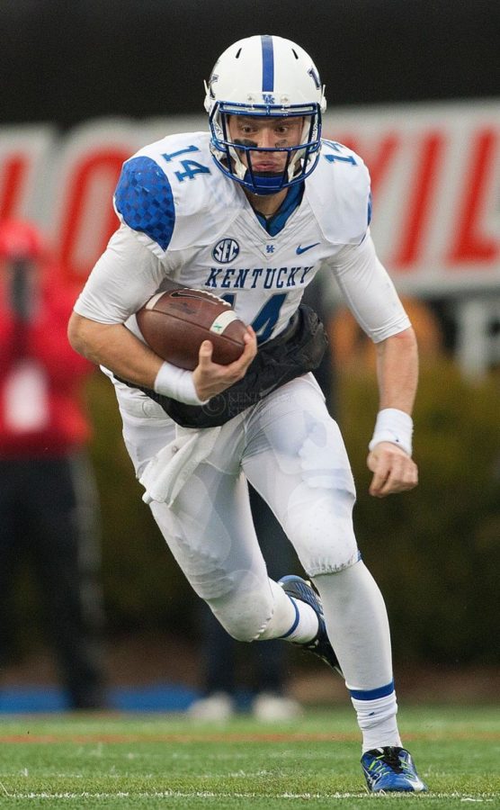 Quarterback+Patrick+Towles+of+the+Kentucky+Wildcats+runs+during+the+second+half+of+the+game+against+the+Louisville+Cardinals+at+Papa+Johns+Cardinals+Stadium+on+Saturday%2C+November+29%2C+2014+in+Louisville%2C+Ky.+Louisville+defeated+Kentucky+44-40.+Photo+by+Michael+Reaves