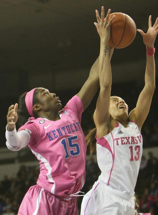 UK guard Linnae Harper (15) and Texas A&amp;U guard Chelsea Jennings attempt to rescue a ball that had gone airborne from a missed shot towards the basket during the second half of the UK women's basketball game against Texas A&amp;U in Memorial Coliseum on Monday, February 18, 2015. Photo by Marcus Dorsey