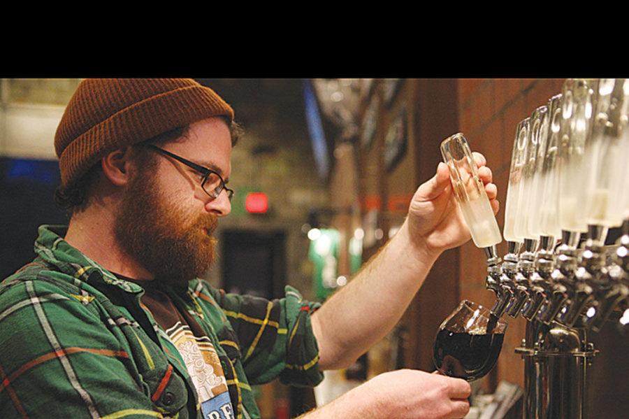Brewer Andrew Brunson pours a beer for a customer at Ethereal Brewery in Lexington, Ky., on Thursday, March 12, 2015. Photo by Adam Pennavaria