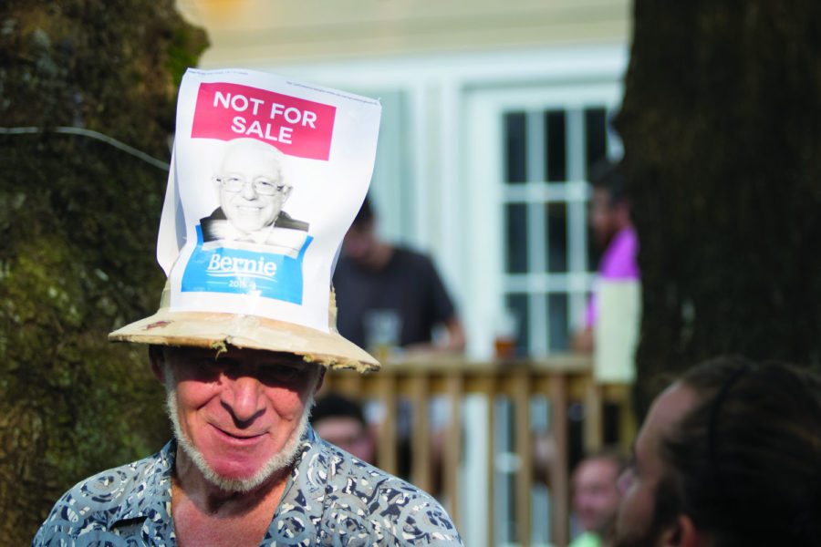 ​Charles Bowsher dons a hat with a portrait of Bernie Sanders at the Bernie Sanders rally at Al's Bar on North Limestone on July 29, 2015. Photo by Marcus Dorsey