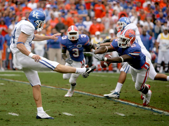 Florida's Jeffery Demps blocks UK punter Tim Masthay during the first quarter of the UK-Florida game on Saturday. The Gators blocked consecutive punts on UK's first two possessions to start the game. Photo by Brad Luttrell