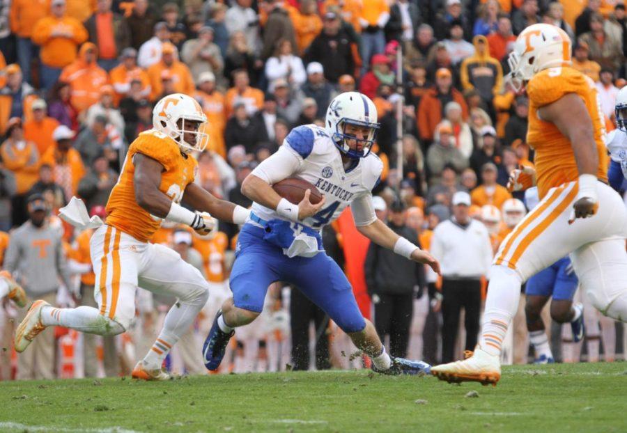 Kentucky+quarterback+Patrick+Towles+tries+to+avoid+the+Tennessee+defense+during+a+run+during+the+first+half+of+the+University+of+Kentucky+vs.+University+of+Tennessee+mens+football+game+at+Neyland+Stadium+in+Lexington%2C+Tn.%2C+on+Friday%2C+November+14%2C+2014+Photo+by+Jonathan+Krueger