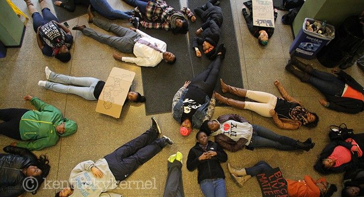 Protestors lie on the floor of the Patterson Office Tower lobby to symbolize those who have been killed at the hands of a police office. Tuesday, December 9, 2014 in Lexington. Photo by Joel Repoley