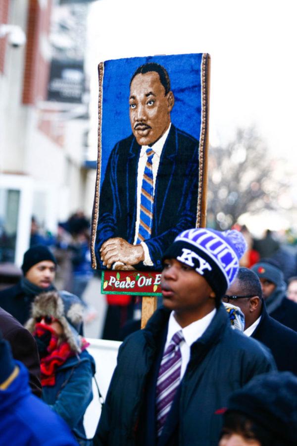 Participants in the Lexington Martin Luther King Day parade march downtown on Monday, January 18, 2016 in Lexington, Ky.
