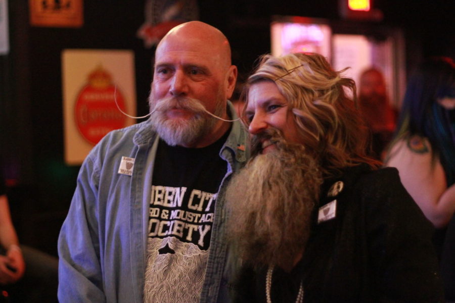 Micki Martin of the Bearded Lady Club poses for a picture with a member of the Queen City Beard and Mustache Society at Cosmic Charlies nightclub in 2012. Photo by Brandon Goodwin | Staff