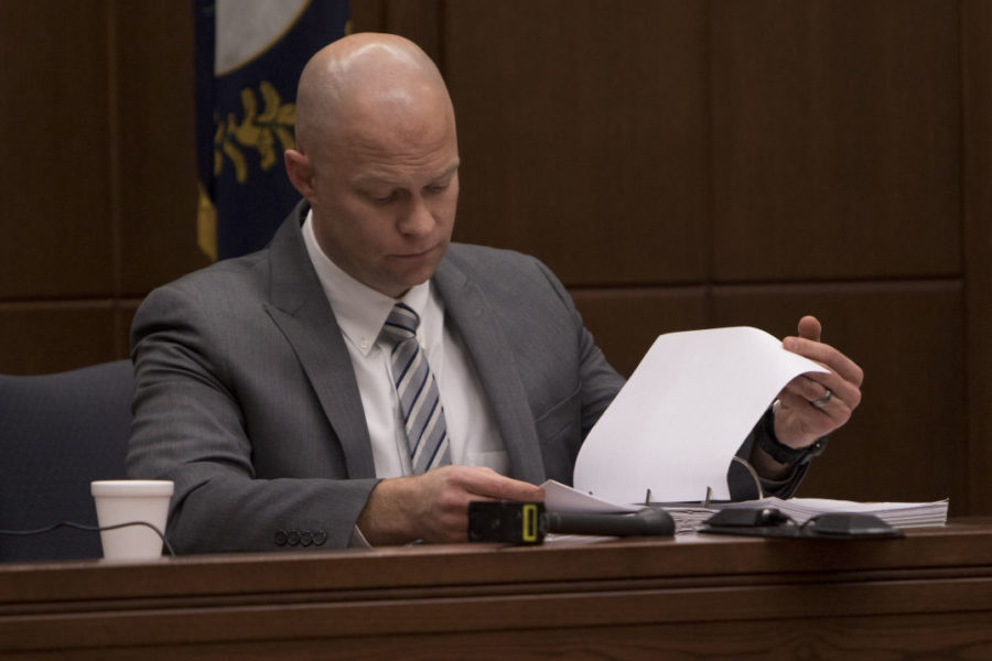Lexington Police robbery and homicide detective Reid Bowles flips through his notes during a bond hearing for the 3 suspects involved in the murder of former Kernel photo editor Jonathan Krueger at the Fayette County Circuit Court in Lexington, Ky. on Friday, February 5, 2016. Photo by Michael Reaves | Staff.