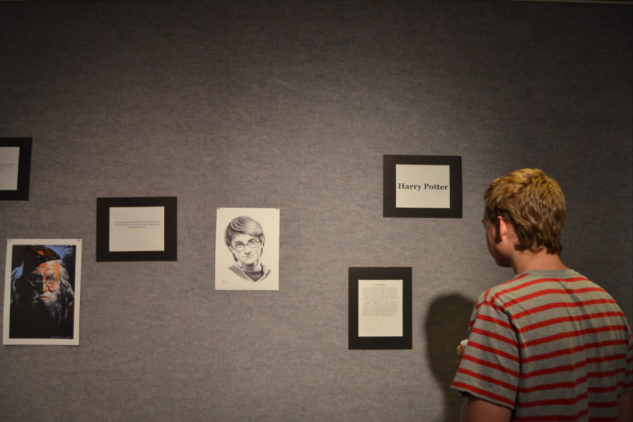 Freshman mechanical engineering student Phillip Brochu admires the Harry Potter art during Student Activities Boards Nerd Night event in the Rasdall Gallery in Lexington, Ky., on Thursday, October 2, 2014. Photo by Cameron Sadler | Staff
