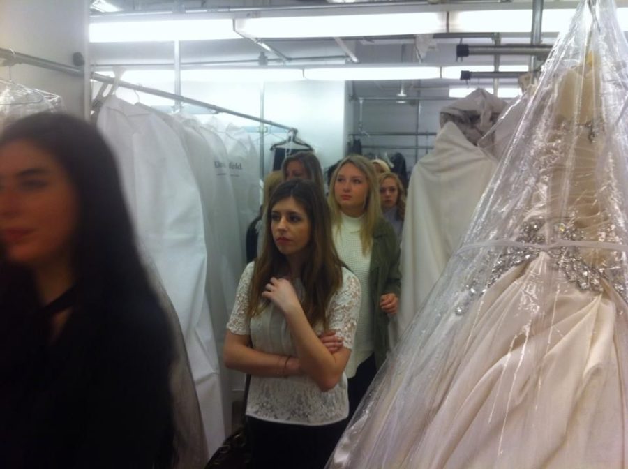 UK students take a walk through Kleinfield Bridal material during their trip.
