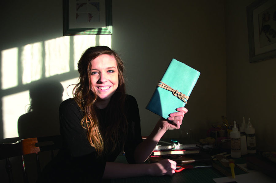 Hannah Davis, arts administration and digital and mass media communications junior, with one of her handmade journals.