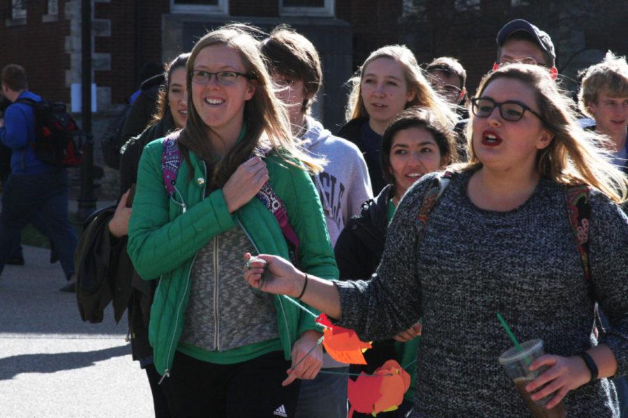Ashleigh McGuire (right) and Alaina Smith (left) lead Greenthumb’s march across campus to President Eli Capilouto’s office. Photo by Will Wright | Staff