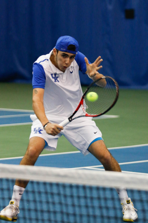 Enzo Wallart hits the ball at the net during the match against the Arkansas Razorbacks on Friday, March 4, 2016 in Lexington, Ky. Kentucky won the match 5-2. Photo by Hunter Mitchell | Staff