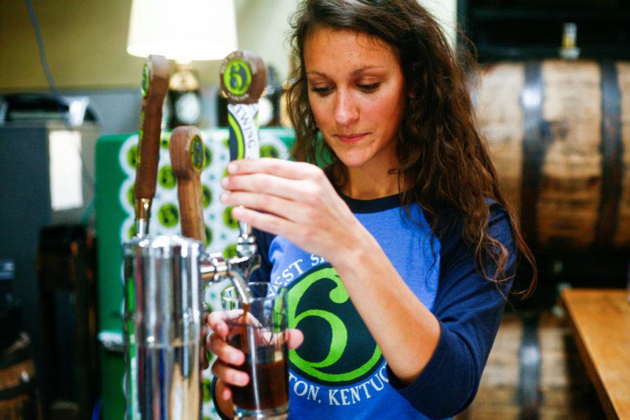 West Sixth employee Kaitlyn Colberg pours a sample beer at West Sixth Brewing on Sunday, October 18, 2015 in Lexington, Ky. Photo by Adam Pennavaria | Staff