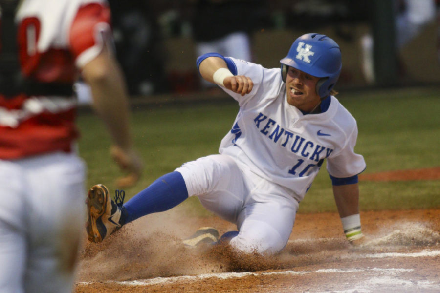 Catcher Luke Becker slides into home safely during the game against the Louisville Cardinals at Cliff Hagan Stadium in , Ky. on Wednesday, April 13, 2016. Photo by | Staff.