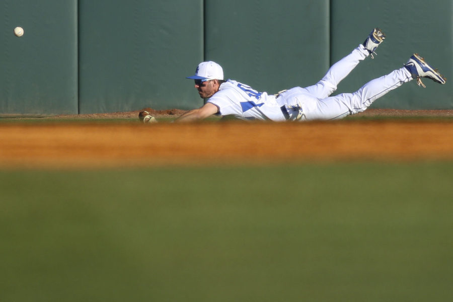Left fielder Zach Reks can't catch a hit as he dives during the game against the Louisville Cardinals at Cliff Hagan Stadium in , Ky. on Wednesday, April 13, 2016. Photo by | Staff.