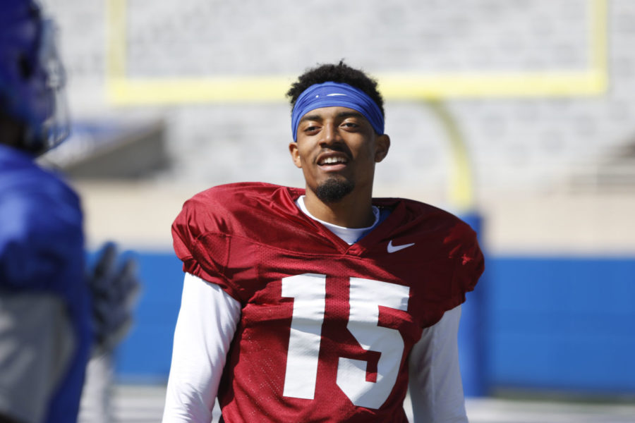 Stephen Johnson II talks with a receiver during the first open practice at Commonwealth Stadium in Lexington, Ky. on Saturday, March 26, 2016. Photo by Josh Mott | Staff.