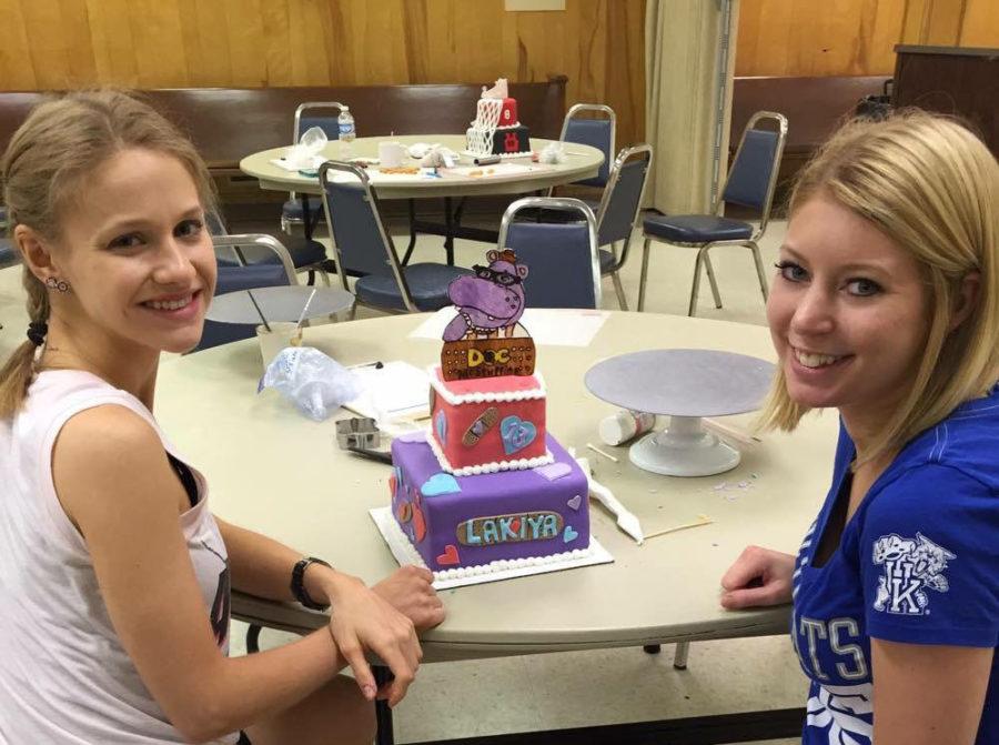 Human health science sophomore Catherine Graham and nursing junior Rachel Hyder decorate a cake through Sweet Blessings, an organization that provides decorated cakes to families who cannot typically afford them. Photo provided by Alex Kerns
