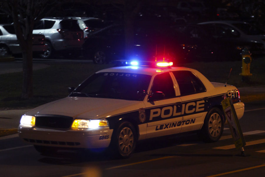 A Lexington police car escorts an ambulance on the corner of Woodland Avenue and Columbia after reports of shots fired on Saturday. Photo by Michael Reaves | Staff