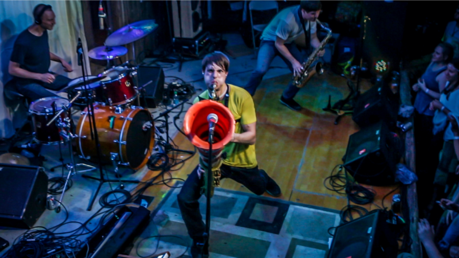 One of Moon Hoochs saxophonists Wenzl McGowen performs on stage with his bandmates at the 2015 Moonshiners Ball. To modify their sounds, both McGowen and Mike Wilbur add items like traffic cones and PVC pipes.