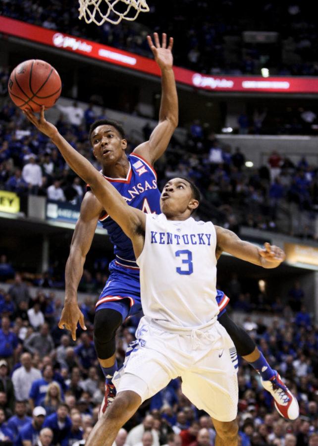 Kentucky freshman Tyler Ulis gets hit while driving to the basket during the second half of the University of Kentucky vs. Kansas University mens Basketball game at Bankers Life Fieldhouse in Indianapolis , In., on Tuesday, November 18, 2014 Kentucky won 72-40 over Kansas. Photo by Jonathan Krueger | Staff