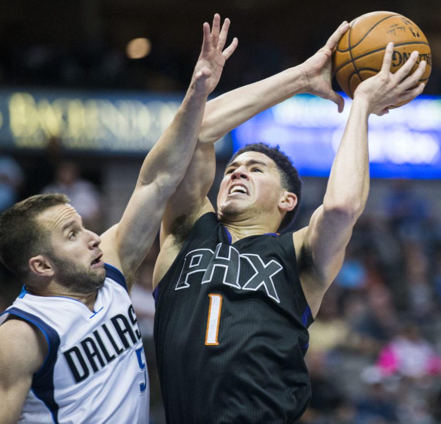 Dallas Mavericks guard J.J. Barea (5) tries to block the shot of Phoenix Suns guard Devin Booker (1) during the third quarter on Sunday, Jan. 31, 2016, at the American Airlines Center in Dallas. (Ashley Landis/Dallas Morning News/TNS)