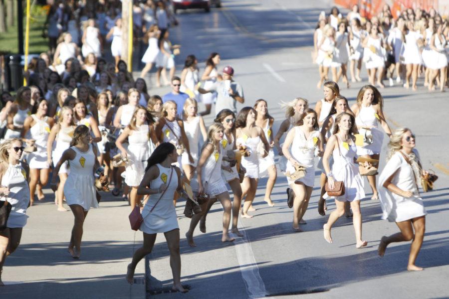 Newly selected sorority women race down Rose Street Sunday after hearing which awaiting house on Greek Row would become their new home-away-from-home. Photo by Josh Mott | Staff