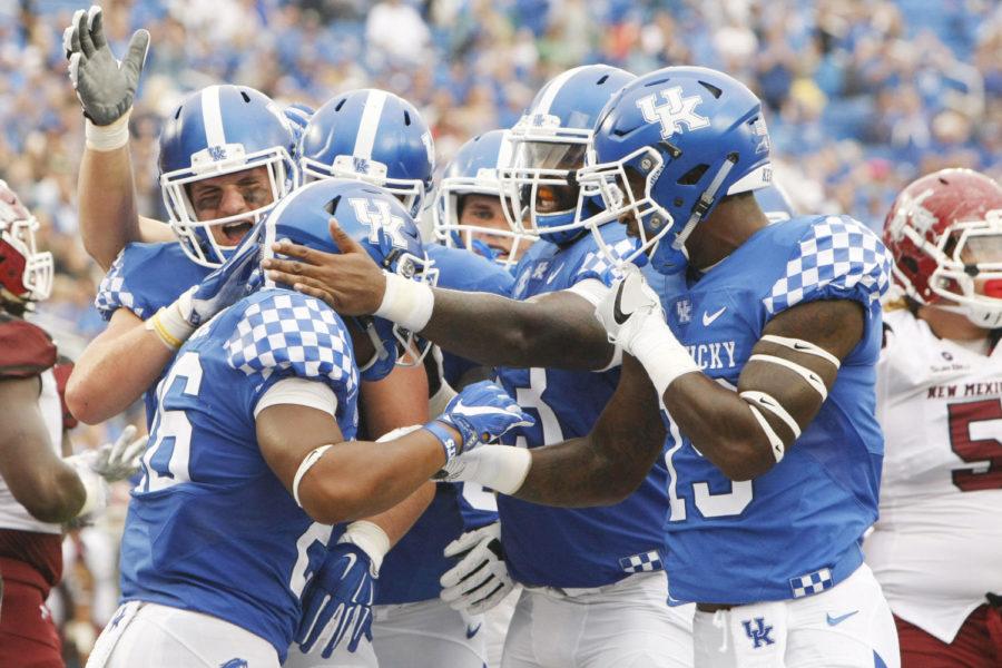 The University of Kentucky football team celebrates after scoring a touchdown during the game against New Mexico State on Saturday, September 17, 2016 in Lexington, Ky. Photo by Hunter Mitchell | Staff
