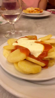 1)     Patatas Bravas. Fried pieces of potatoes served with a spicy tomato aioli sauce