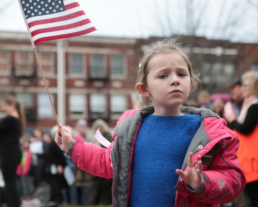 A+young+girl+waves+an+American+flag+at+an+event+in+solidarity+with+the+Womens+March+on+Washington+in+Lexington%2C+Ky.%2C+on+Saturday%2C+January+21%2C+2017.+Thousands+of+people+gathered+in+front+of+Fayette+Countys+district+and+circuit+courts+and+marched+through+the+city+to+protest+President+Donald+Trumps+inauguration.+Photo+by+Joshua+Qualls+%7C+Staff