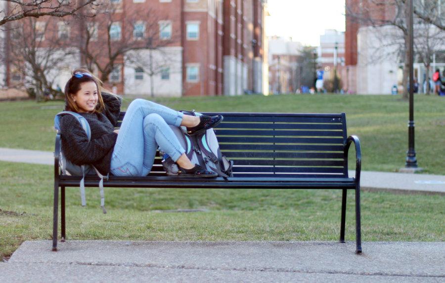 Student relaxing on a bench outside of the William T. Young library at the University of Kentucky in Lexington, Ky. on Tuesday, March 8, 2016. Photo by Josh Mott | Staff.