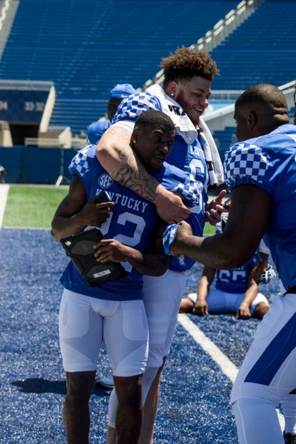 Members of the University of Kentucky Football Team hangout on the field during the media day at Kroger Field on Sunday July 30, 2017 in Lexington, KY.