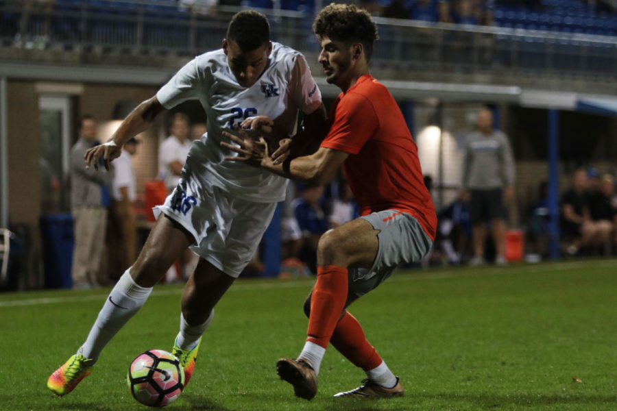 Freshman JJ Williams powers past a defender during the game against Bowling Green State University on Tuesday, October 18, 2016 in Lexington, Ky. Kentucky won the match in extra time 1-0. Photo by Carter Gossett | Staff