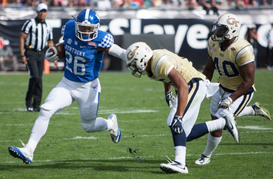 Running back Benny Snell Jr. #26 of the Kentucky Wildcats carries the ball for a short gain during the first half of the TaxSlayer Bowl against the Georgia Tech Yellow Jackets at EverBank Field on Saturday, December 31, 2016 in Jacksonville, Florida. Photo by Addison Coffey | Staff.