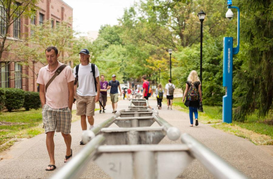 People walk between Lafferty Hall and the Lucille Little Library during UKs first day of classes in Lexington, Ky. on Wednesday, August 26, 2015. Photo by Adam Pennavaria | Staff