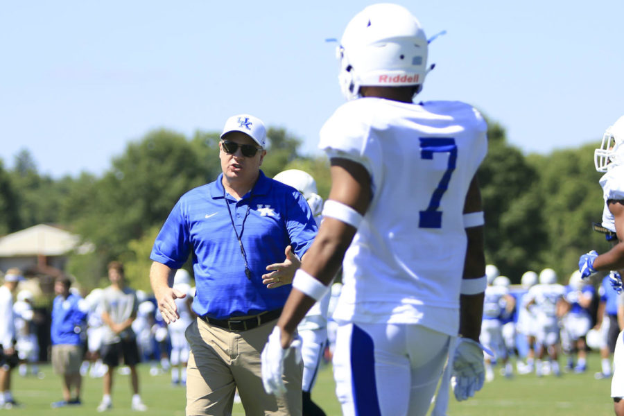 Kentucky Wildcats head coach Mark Stoops coaches up Mike Edwards during the open practice at the Joe Craft Football Training Facility on Saturday, August 5, 2017 in Lexington, KY. Photo by Addison Coffey | Staff