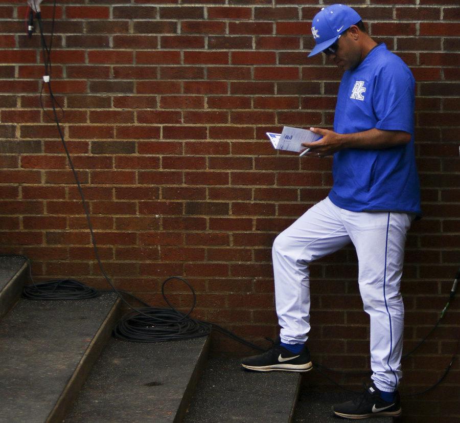 Kentucky Wildcats head coach Nick Mingione studies a scouting report in-between innings of the region championship game of the Lexington Regional at Cliff Hagan Stadium on Sunday, June 4, 2017 in Lexington, KY. Photo by Addison Coffey | Staff.