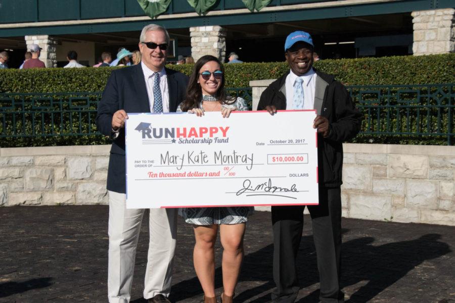 Bernie Sams, the stallion manager at Claiborne Farm (left) and Cordell Anderson, Keeneland Ringman and RunHappy groom and check presenter (right) award Mary Kate Montroy with a $10,000 scholarship on College Scholarship Day at Keeneland on Friday, October 20, 2017 in Lexington , Kentucky. Photo By Genna Melendez | Staff