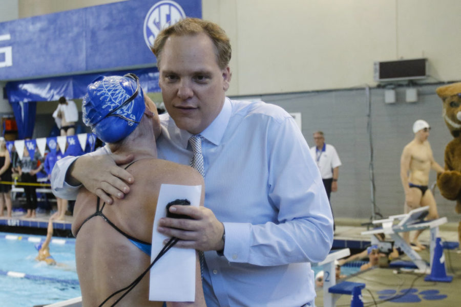 UK head coach Lars Jorgensen hugs signee Madison Winstead after she swam the 100m breaststroke during the UKs Sun Shall Shine Blue and White meet at Lancaster Aquatic Center in , Ky. on Friday, April 22, 2016. Photo by Michael Reaves | Staff.